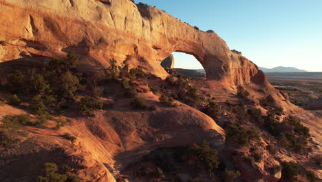 aerial view of natural arch, red sandstone formation in wilderness of utah usa, drone shot