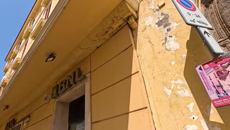 yellow building with signs and archway