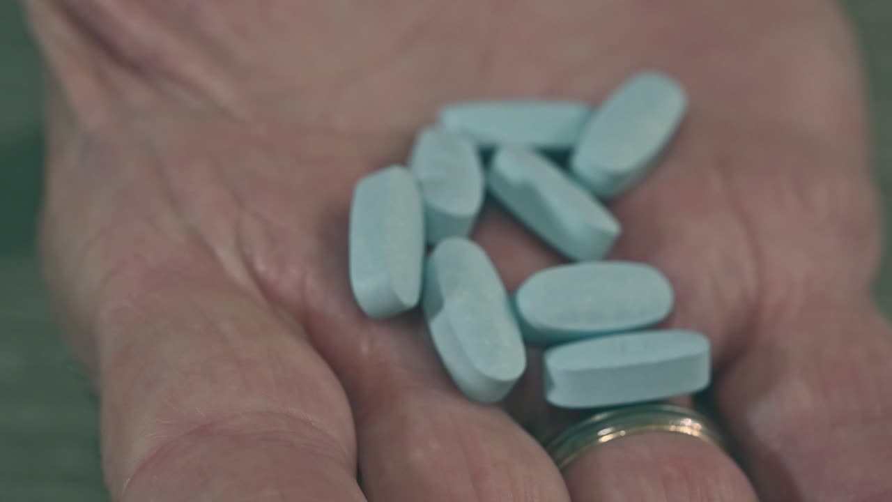 어두운 장면 고령 시민의 손이 열려 약물의 보관소를 드러 ⁇ 니다.