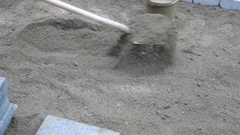 laying sand for paving