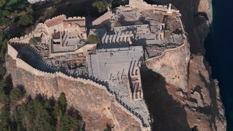 tight aerial circling shot over the lindos acropolis