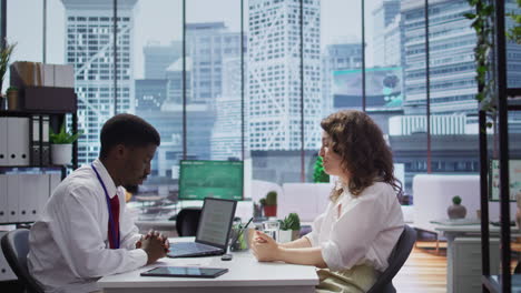 african american interviewer discussing with candidate about company objectives
