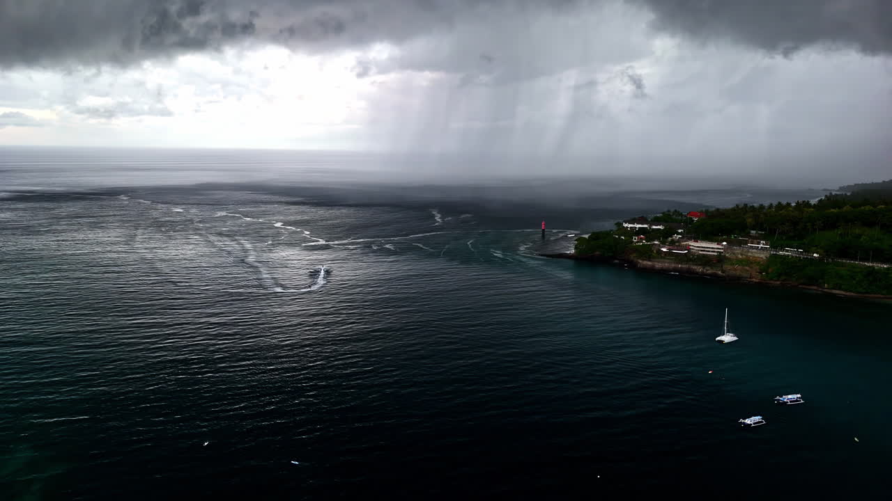 Black and white drone aerial of dramatic storm clouds over Senggigi Beach Lombok coastline
