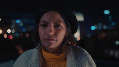 portrait-funny-mixed-race-woman-on-rooftop-at-night-making-faces-enjoying-urban-nightlife-with-bokeh-city-lights-in-background