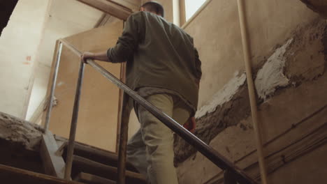 woman going upstairs in basement workshop