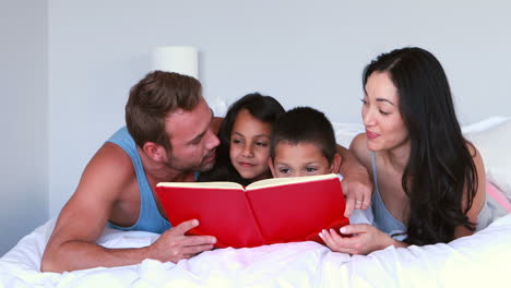 familia feliz leyendo el libro rojo