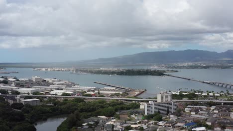 aerial wide dolly shot of pearl harbor with the uss arizona memorial in the background on the island of o'ahu, hawaii