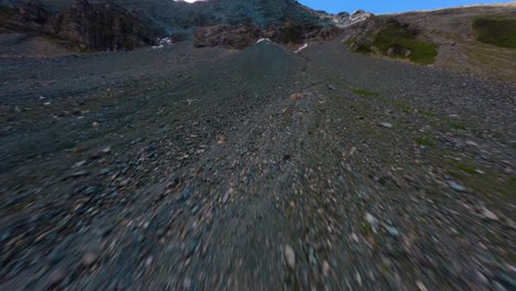 fpv drone flight approaching a rocky mountain along the grossglockner alpine road in austria