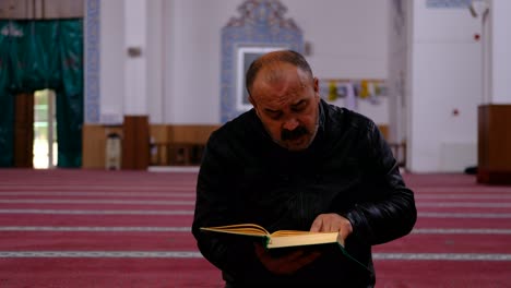 middle age man reads quran in mosque 2