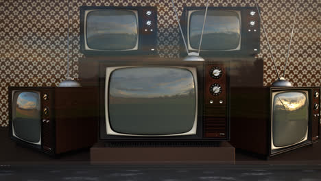 An-exhibition-of-old-fashioned-retro-color-tv-sets-with-antennas.-Electronic-devices-stack-in-front-of-vintage-wallpaper.-Obsolete-television-is-displaying-a-green-screen.