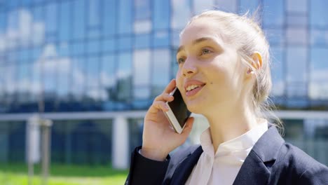 Young-student-talking-phone-on-street