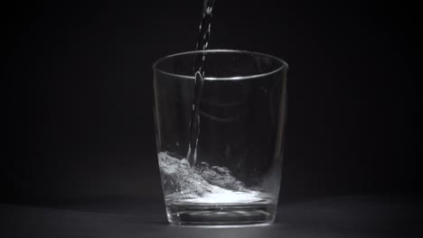 mineral water in a transparent glass in slow motion