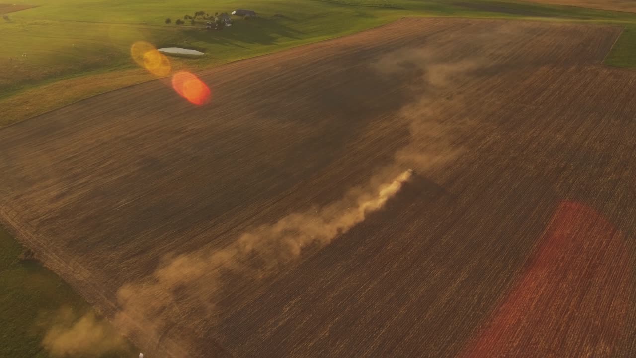 Heavy Agricultural Machinery With Implements In Agricultural Fields On A Sunny Summer Evening. Aerial Dolly-In Pedestal-Down Shot
