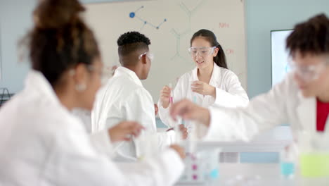 diverse students conduct experiments in a high school lab