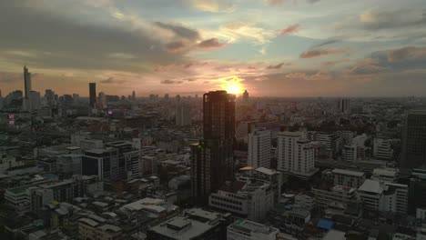 sunset behind skyline skyscrapers