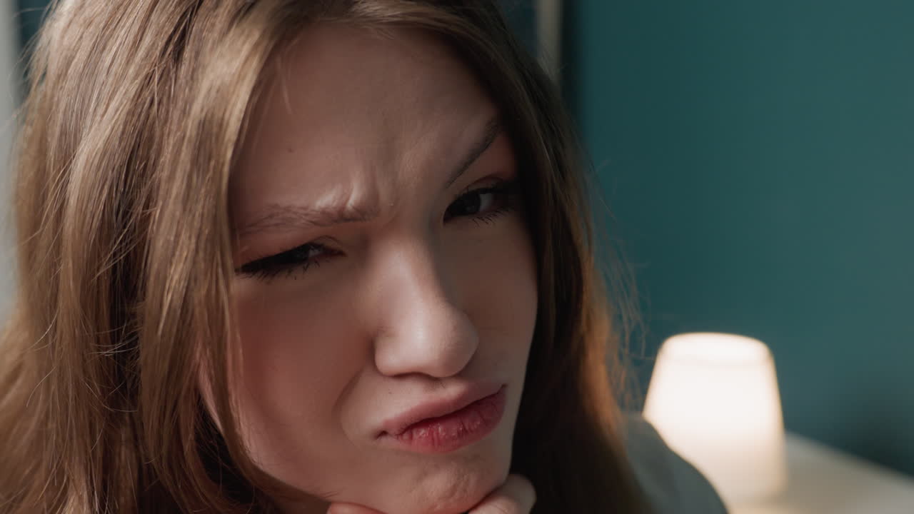 Playful caucasian teen making silly faces in cozy bedroom with teal wall and lamp, closeup shots capture pout, wink, grin, thoughtful pose, influencer rehearsal, morning mirror routine, authentic