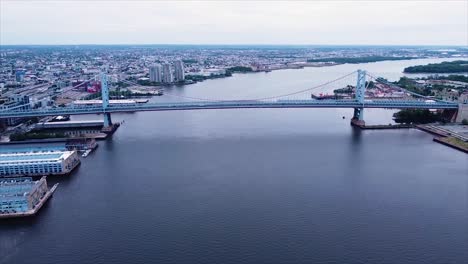 drone shot over the delaware river of the ben franklin bridge