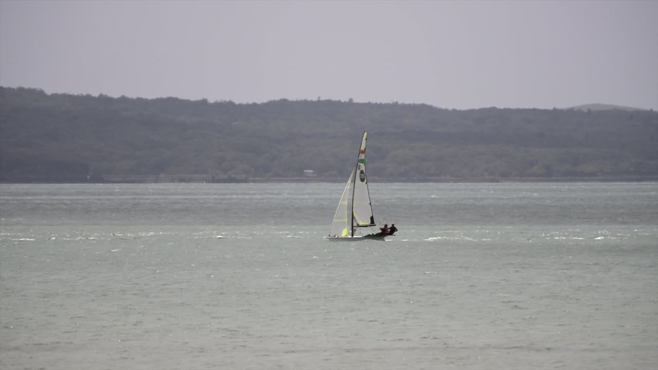 Sailing boats capturing wind and surfing through waves