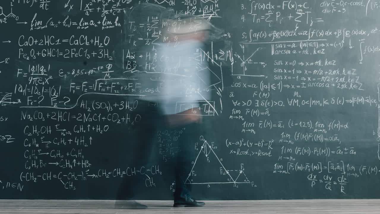 Professor in front of a chalkboard full of equations