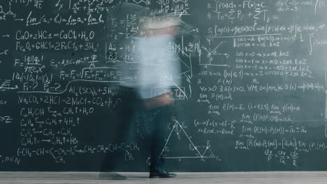 professor in front of a chalkboard full of equations