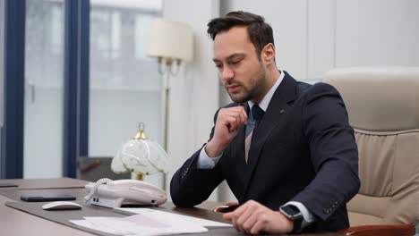 stress, anxiety and worried business man working in an office, looking nervous and upset while looking through paper documents or sales reports, he can't accept or believe his eyes