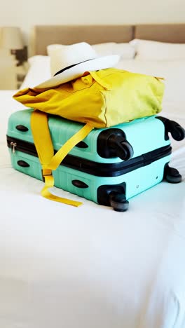travel bag and backpack on a bed.