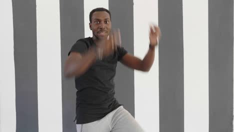young hipster handsome afroamerican black man dancing hip hop style.
