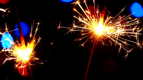 close-up shot of sparklers and colorful flashes of bokeh light