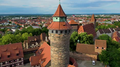 4k aerial drone video of the heidenturm heathens' tower and fünfeckturm five-cornered tower on the imperial castle in downtown nurnberg, germany