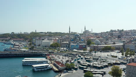 Rush-Hour-at-Grand-Bazaar-in-Istanbul-with-Bus-and-Cars-and-Mosque-on-a-Hill,-Slow-Aerial-Drone-forward-shot