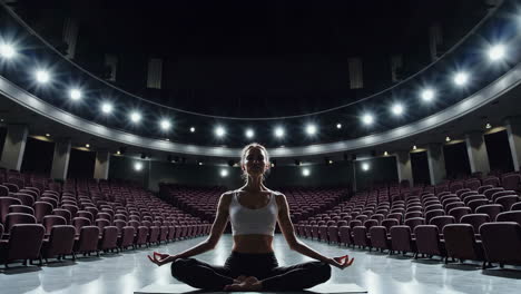 woman meditating in an empty auditorium