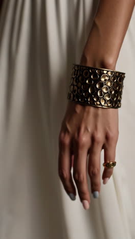 elegant bronze cuff bracelet and ring on a woman's arm