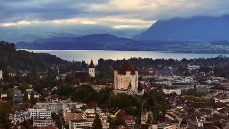 Aerial cinematic drone Thun Bern Switzerland Swiss village city downtown lake cars stunning Thun Castle Dukes of Z&auml;hrigen Interlocken Jungfrau cloudy sunrise sunset circle slowly right movement