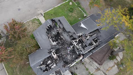 Family-disaster---burned-down-home,-aerial-top-down-view