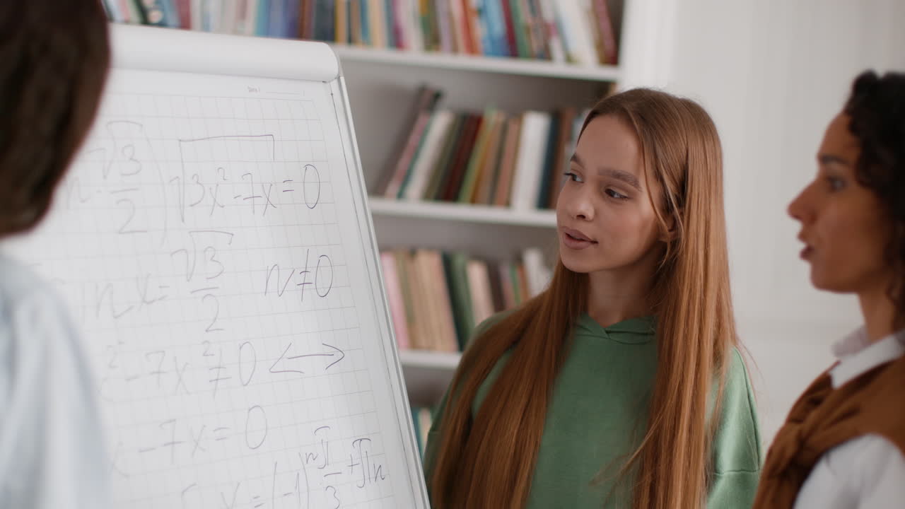 Students Collaborating on Math Problems with a Whiteboard