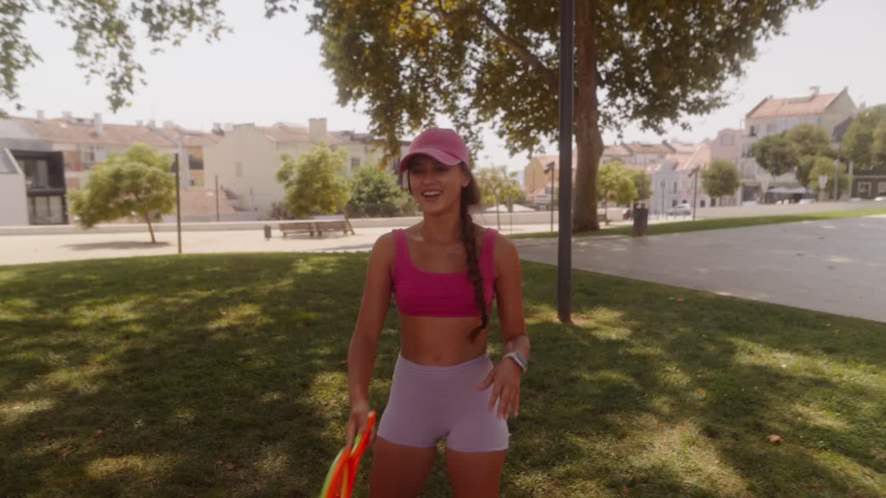 Woman playing racket sport in park