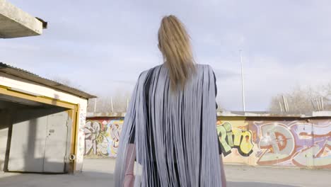 stylish woman in urban setting with fringe jacket