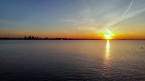 Aerial-sunset-seascape-view-of-Baltic-Sea-with-Tallin-capital-city-of-Estonia-in-background