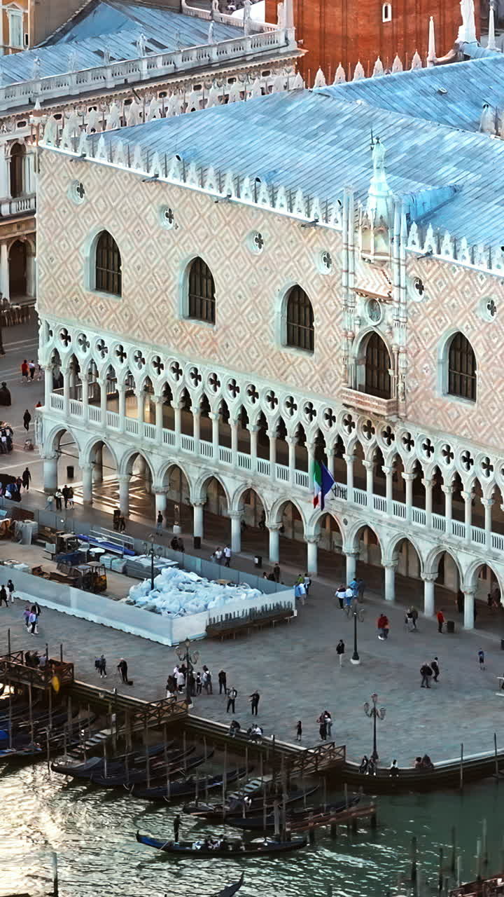 Aerial drone view of Doge's Palace in St. Mark's Square, near a harbour in Venice City, Italy, at sunset. Vertical