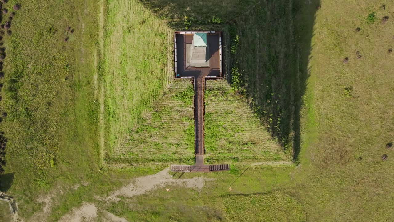 Top down aerial showing historic Austerlitz Pyramid built by Napoleon in the Netherlands, surrounded by forest landscape on a bright sunny day