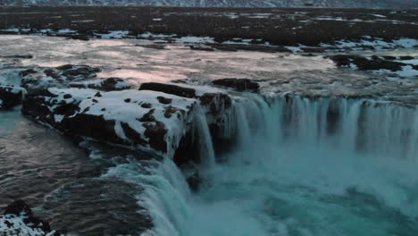 aerial view of godafoss waterfall, iceland, cold glacial water in winter scenery in icelandic highlands, drone shot