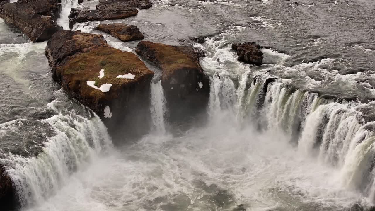 Goðafoss waterfall surging over rocky cliffs in Iceland's Skjálfandafljót river