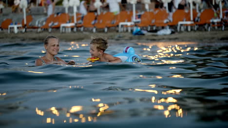 mother and son swimming in the evening