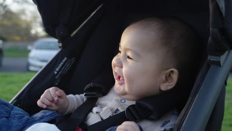 baby in stroller laughing and smiling