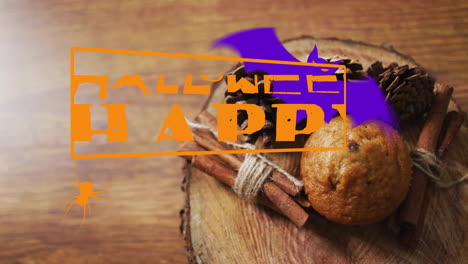 halloween happy text animation over muffin and cinnamon sticks on wooden surface