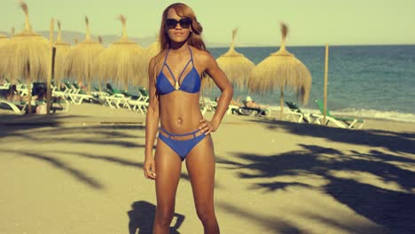 sexy african girl at the beach looking at distance
