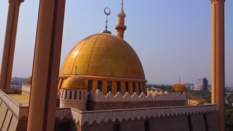 jib up of the golden dome on top of a beautiful mosque in abuja, nigeria