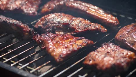 Tasty-ribs-cooking-on-barbecue-grill-for-summer-outdoor-party