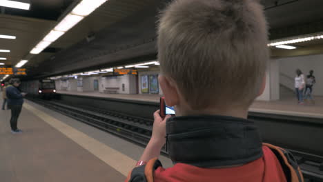 child making his own photos at subway