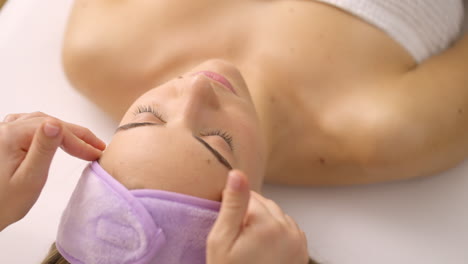 woman receiving a facial massage at a spa